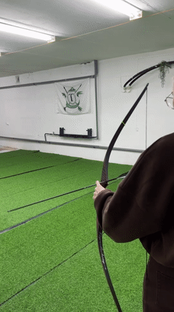 Woman practices archery at indoor range in Naberezhnye Chelny
