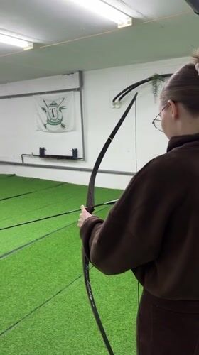 Woman practices archery at indoor range in Naberezhnye Chelny