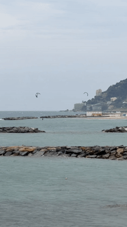 Person takes elevator mirror selfie while holding yogurt in Sanremo
