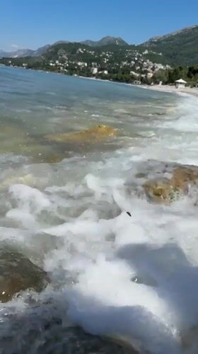 Morning beachgoers enjoy sunny conditions at Bar Montenegro coastline