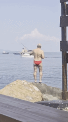 Fishing from the rocks as ships pass through Vladivostok harbor
