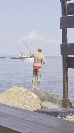 Fishing from the rocks as ships pass through Vladivostok harbor