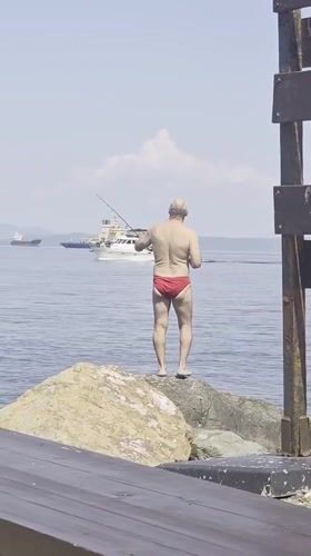 Fishing from the rocks as ships pass through Vladivostok harbor