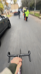 Cyclist rides through quiet Olivos street on overcast day