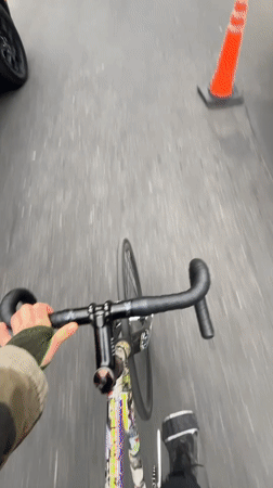 Cyclist rides through quiet Olivos street on overcast day