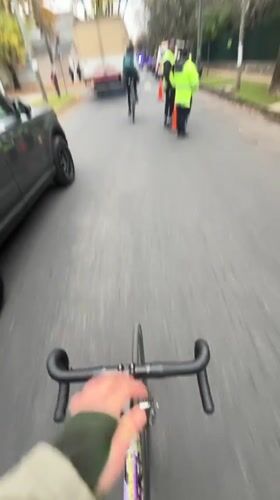 Cyclist rides through quiet Olivos street on overcast day