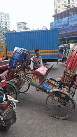 Morning street life in Dhaka: rickshaws, vendors, and dense traffic