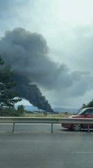 Black smoke plume rises over Sofia under overcast skies