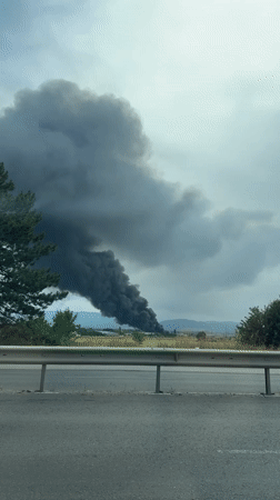 Black smoke plume rises over Sofia under overcast skies