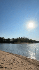 Sunny lakeside beach scene recorded in Vekoshinka, Russia