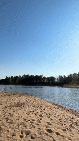 Sunny lakeside beach scene recorded in Vekoshinka, Russia