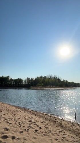 Sunny lakeside beach scene recorded in Vekoshinka, Russia