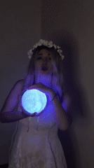 Woman performs with glowing lamp in Budva room
