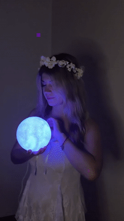 Woman performs with glowing lamp in Budva room