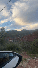 Traveler captures scenic hillside landscape view near Asni, Morocco