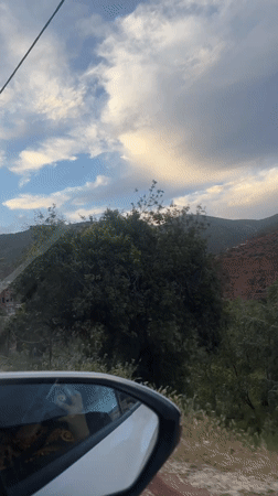 Traveler captures scenic hillside landscape view near Asni, Morocco