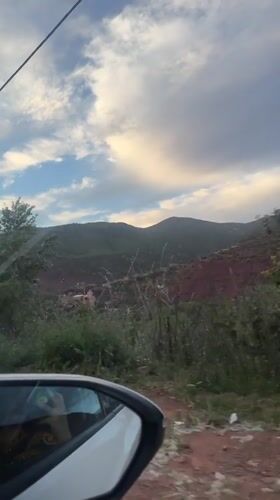 Traveler captures scenic hillside landscape view near Asni, Morocco