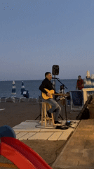 Acoustic performer entertains guests at Montenegro beachside venue