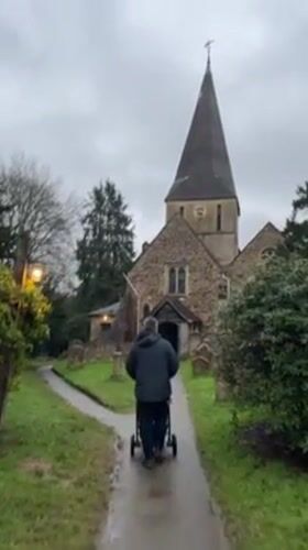 Father walks baby stroller to church in Guildford