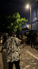 Nighttime crowd gathers on Athens street