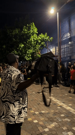 Nighttime crowd gathers on Athens street