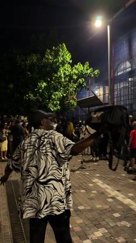 Nighttime crowd gathers on Athens street
