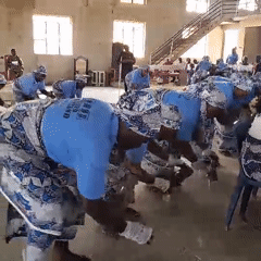 Women perform coordinated dance in traditional dress at Ube hall