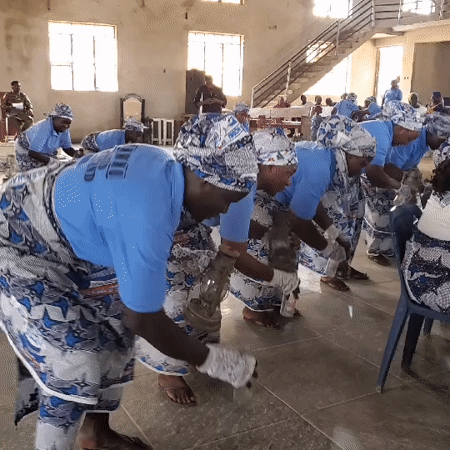 Women perform coordinated dance in traditional dress at Ube hall