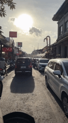 Morning traffic flows through Ubud streets amid traditional architecture
