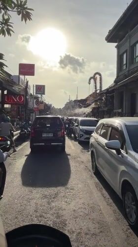 Morning traffic flows through Ubud streets amid traditional architecture