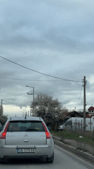 Parked car observed on Sofia street with plane overhead