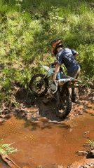 Dirt bikers struggle through muddy Russian forest terrain