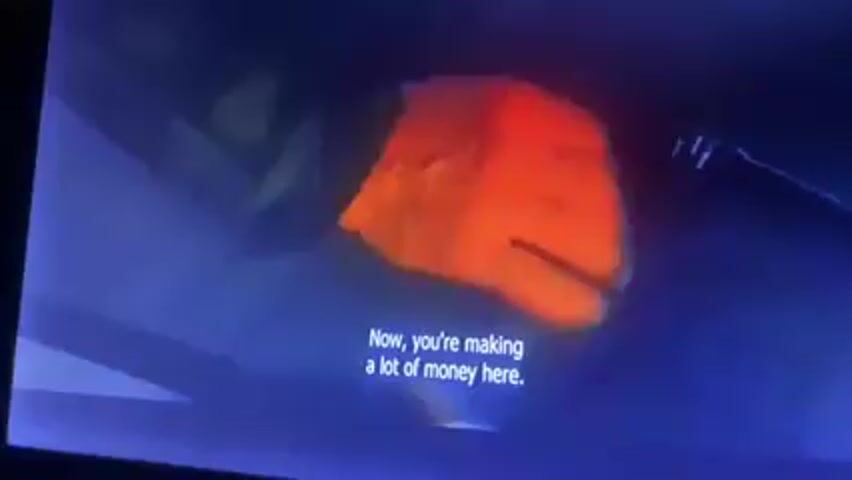 The video shows a scene from a television. A man wearing a flannel shirt says, “Tell me where it’s all going.” Another person responds, “I don’t know, man.” A screen in the background displays the logo for “One Star.” The overall lighting is dim with red and orange tones.