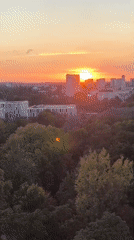 Potsdam skyline glows at golden hour, dome visible on horizon