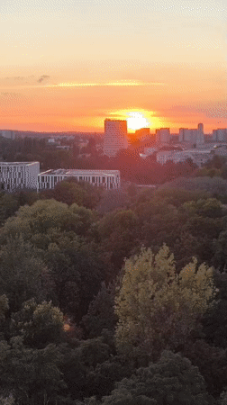 Potsdam skyline glows at golden hour, dome visible on horizon