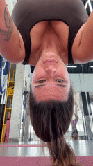 Woman practices aerial yoga in Sukawati studio