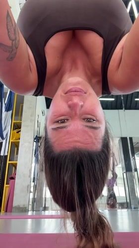 Woman practices aerial yoga in Sukawati studio