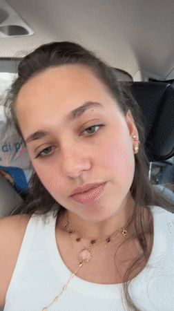 Woman records selfie videos in car in Milan