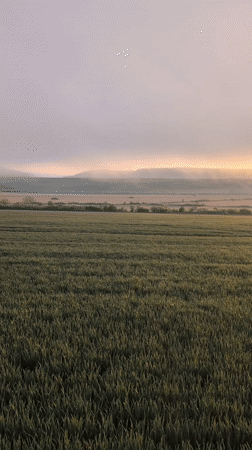 Sunrise observed over misty mountains near Ostrets, Bulgaria