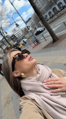 Woman takes selfies near KaDeWe department store in Berlin