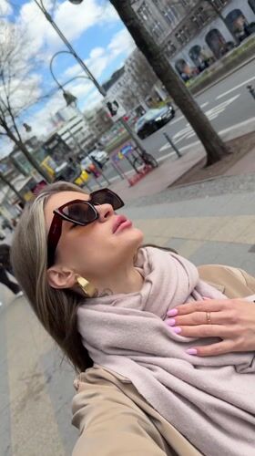 Woman takes selfies near KaDeWe department store in Berlin