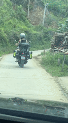 Motorcyclist travels paved road in northern Vietnam early morning