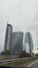Moving vehicle captures Sofia high-rises under overcast sky