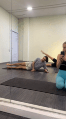 Three people exercise together in fitness studio