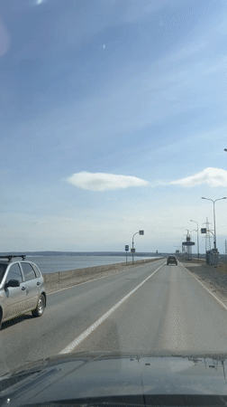 Morning drive along waterfront road captured near Noviy, Russia