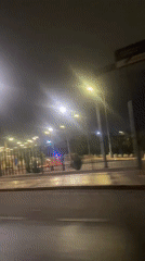 Nighttime drive past illuminated gate captured in Arica, Chile