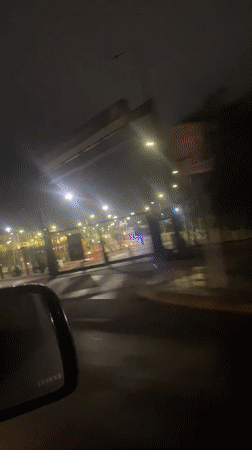 Nighttime drive past illuminated gate captured in Arica, Chile