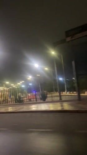 Nighttime drive past illuminated gate captured in Arica, Chile