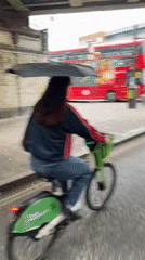 Woman rides Lime e-bike through London streets