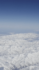 Passenger documents aerial mountain views during Moscow flight segment